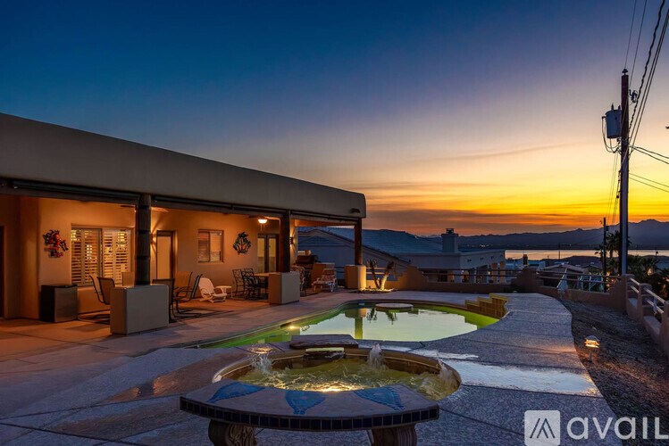 A house with a pool and a hot tub in the backyard.
