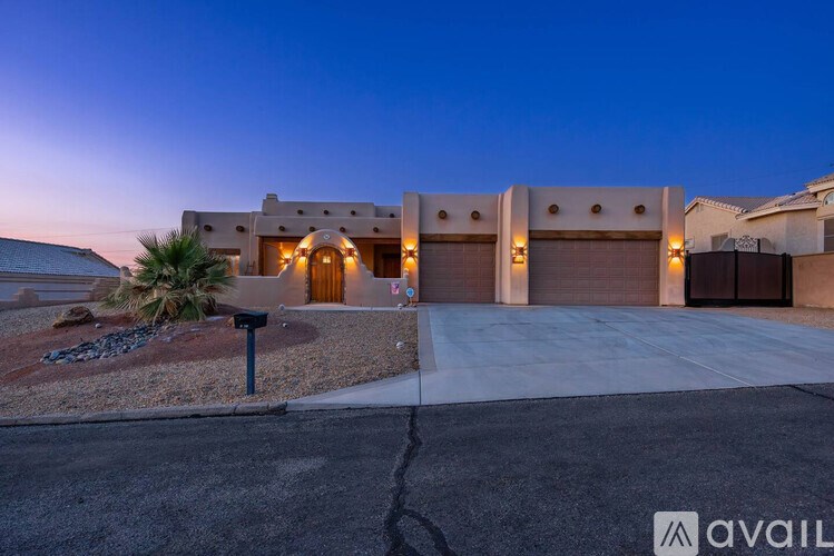 A modern house with a driveway and garage doors.