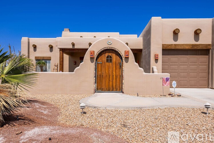 A house with a brown door and a flag on the wall.