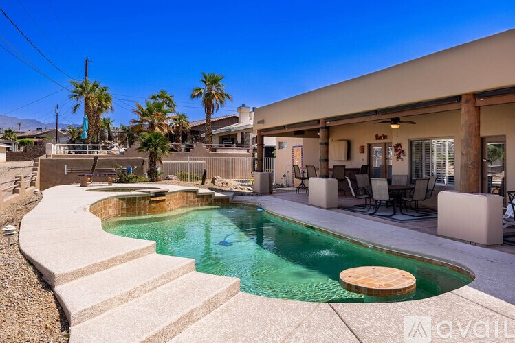 A pool with a hot tub in the middle of a patio.