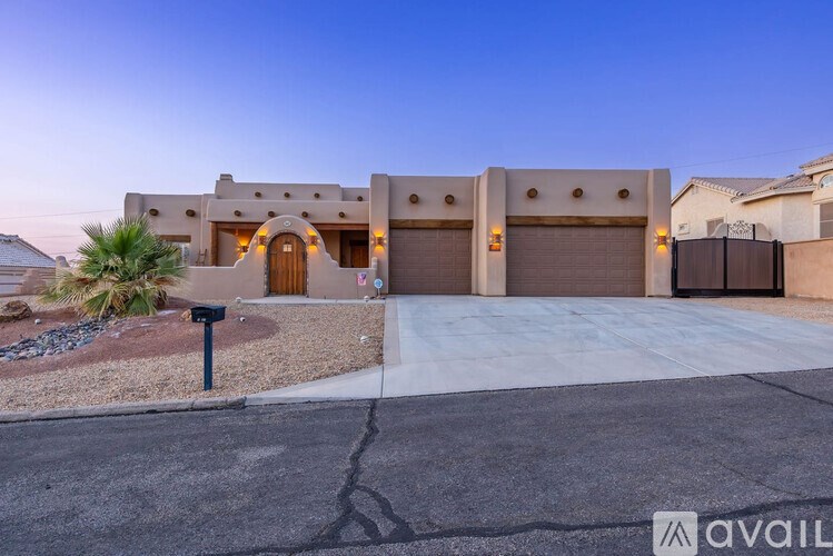 A modern house with a driveway and garage doors.
