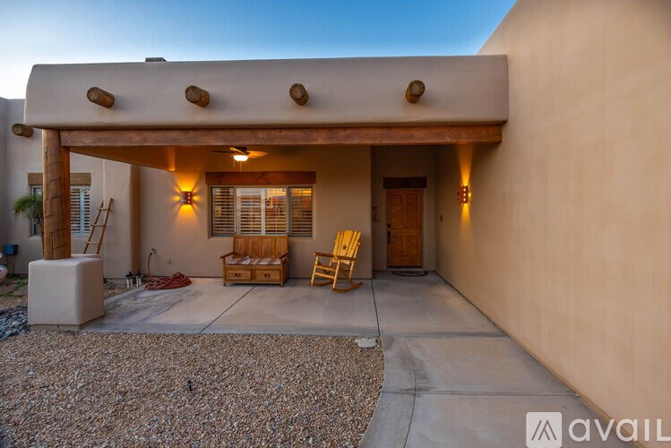A house with a covered patio and a chair.
