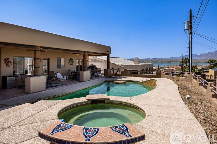 A pool with a tiled edge and a small fountain in the middle.