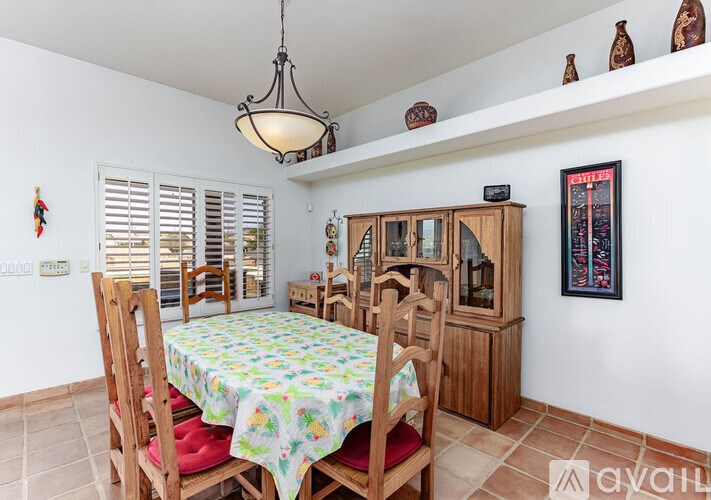A dining room with a table set for four.