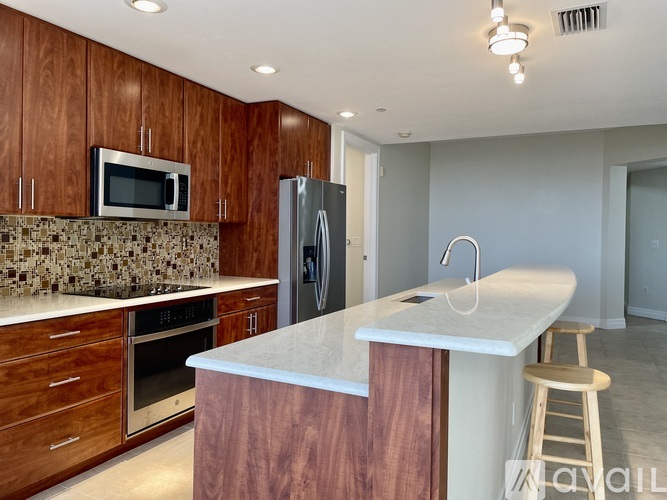 A kitchen with wooden cabinets and a granite countertop.