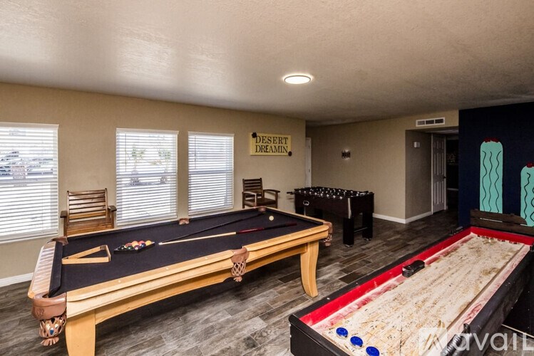A pool table with a wooden frame and a green felt cloth is in the foreground of the image.