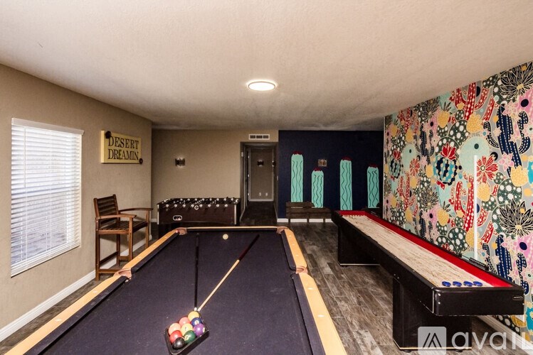A pool table in a room with a sign that says "Desert Dream".