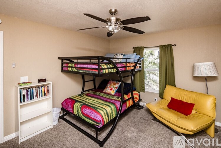 A bedroom with a bunk bed and a yellow couch.