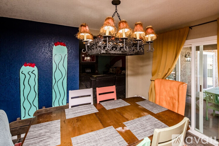 A dining room with a wooden table and chairs.