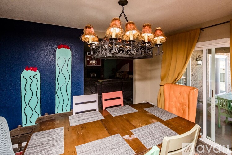 A dining room with a wooden table and chairs.