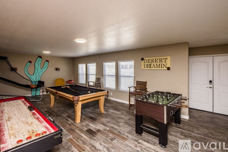 A room with a pool table and a shuffleboard table.