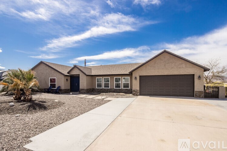 A house with a garage and a driveway is available for sale.