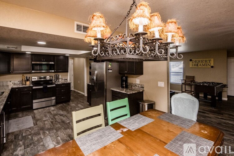 A kitchen with a dining table and chairs.