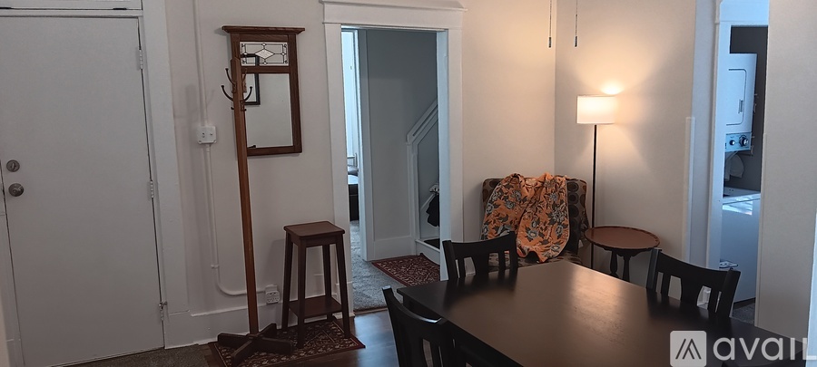 A dining room with a wooden table and chairs.