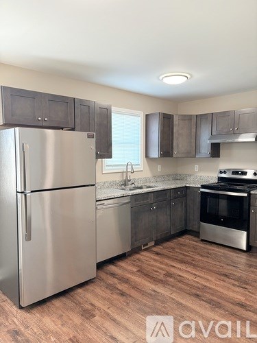 A kitchen with a stainless steel refrigerator and oven.