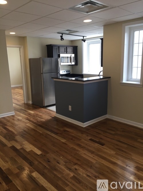 A kitchen with a refrigerator and a microwave.
