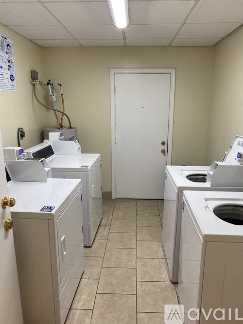 A laundry room with washers and dryers.