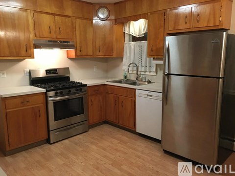 A kitchen with wooden cabinets and stainless steel appliances.