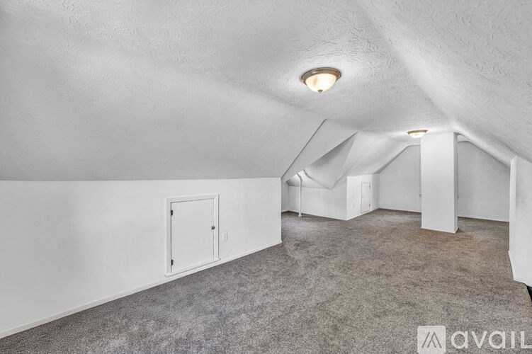 A room with white walls and a carpeted floor.