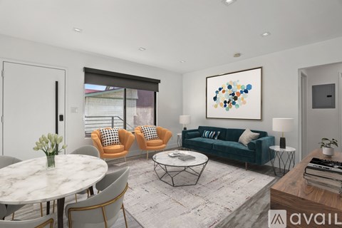 A living room with a white table and chairs.