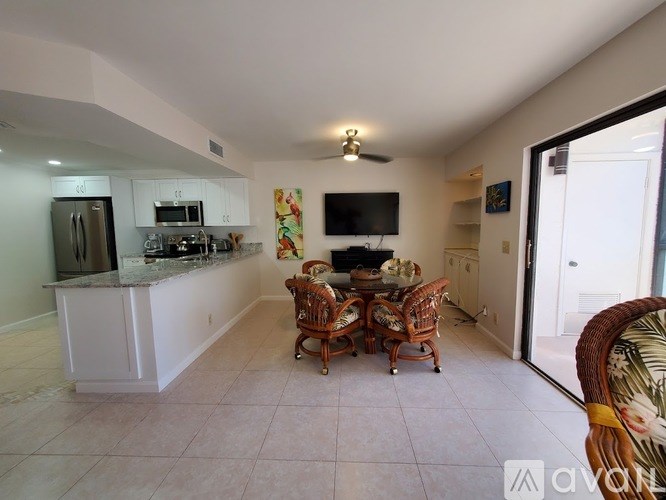 A kitchen with a dining table and chairs.