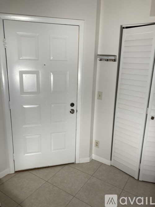 A white door is on the left and a white closet door is on the right.