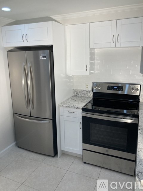 A kitchen with a stainless steel refrigerator and oven.