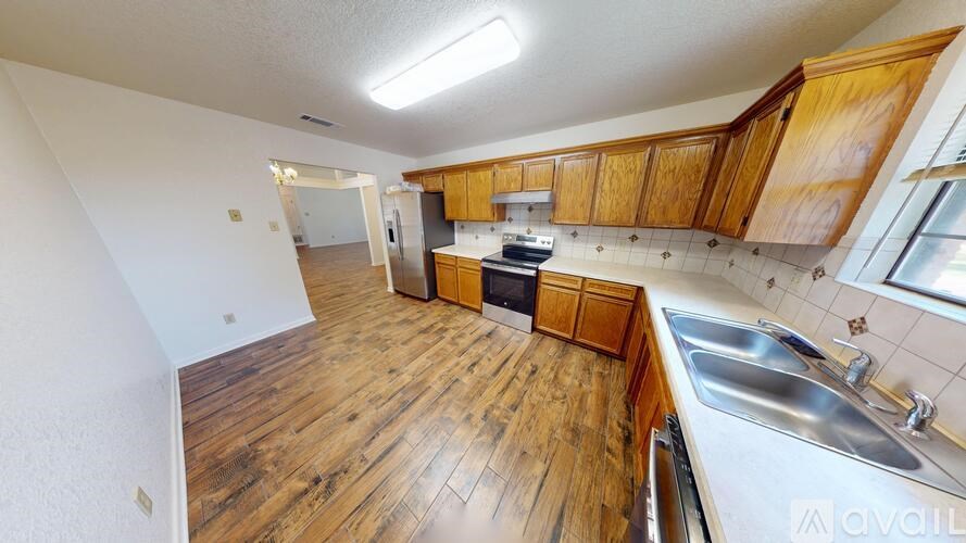 A kitchen with wooden cabinets and a white door.