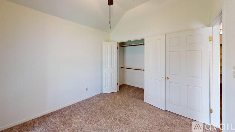 A room with white walls and a carpeted floor.
