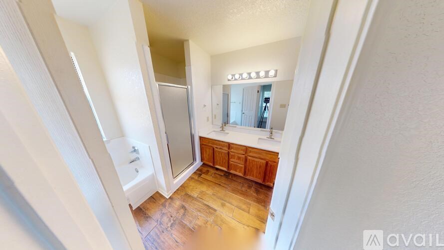 A room with a carpeted floor and a window with blinds.