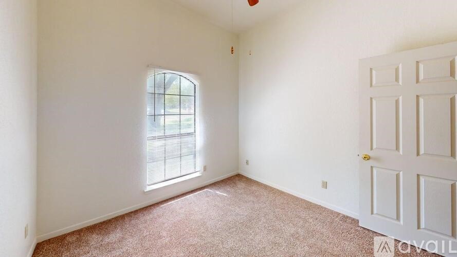 A room with a window and a door is available for rent.