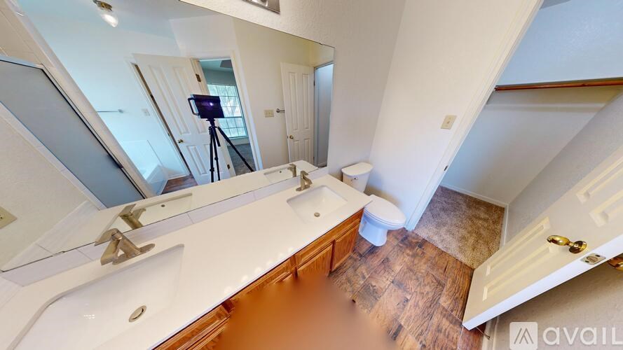 A room with wooden floors and a chandelier.