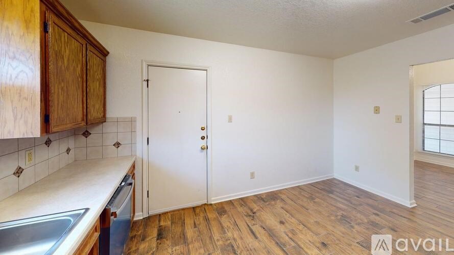 A kitchen with wooden cabinets and a white countertop.