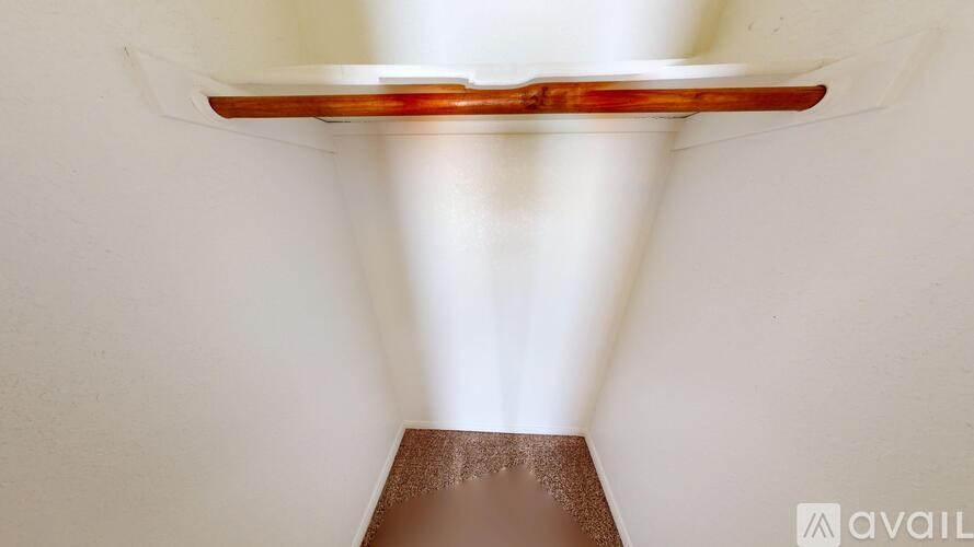 A light fixture with a brown base and a clear glass shade.