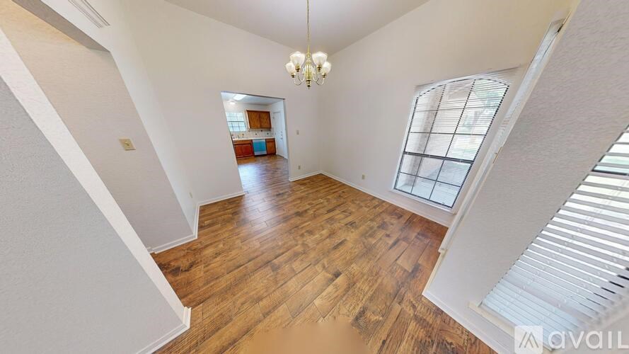 A room with a carpeted floor and a doorway leading to another room.