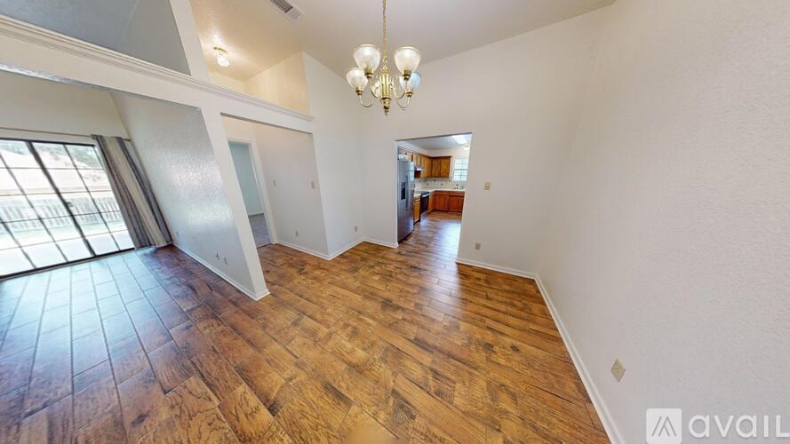 A white wall with a brown trim and a mirror in the hallway.