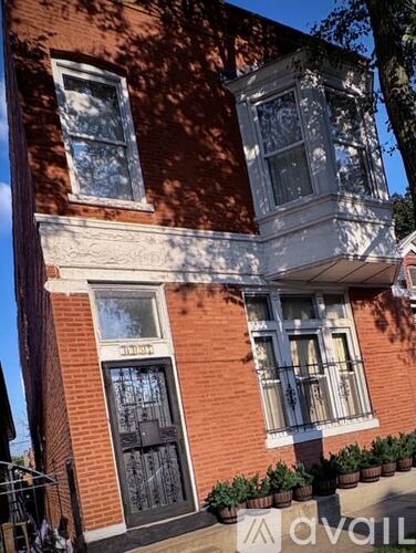 A red brick building with a black door and windows.