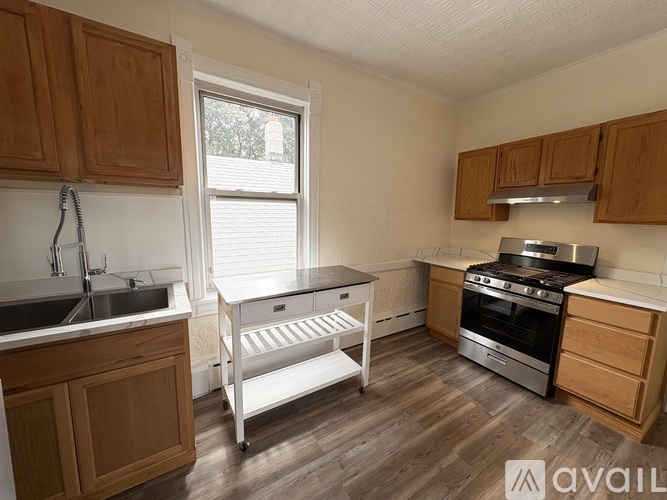 A kitchen with wooden cabinets and a white oven.