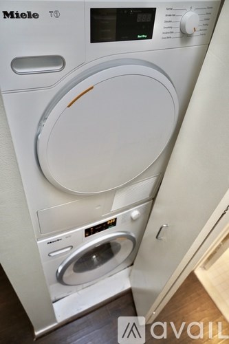 A Miele washing machine with a digital display and control panel.