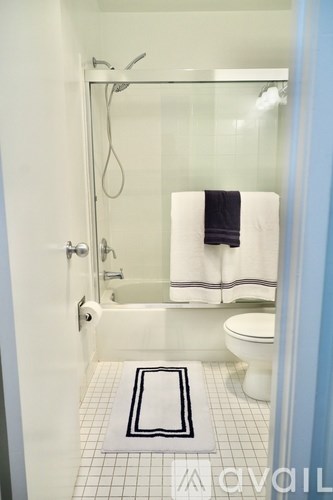 A bathroom with a toilet, a bathtub, and a shower.