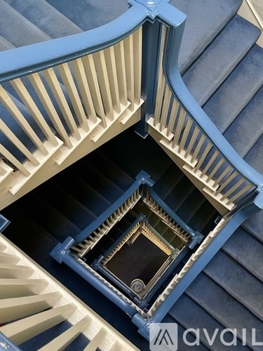A spiral staircase with a square window in the middle.