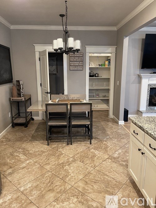 A kitchen with a table and chairs in the middle of the room.