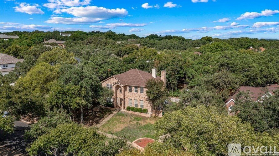 A house surrounded by trees is for sale.