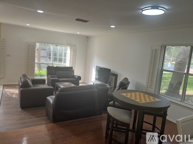 A living room with a chess board on the table.