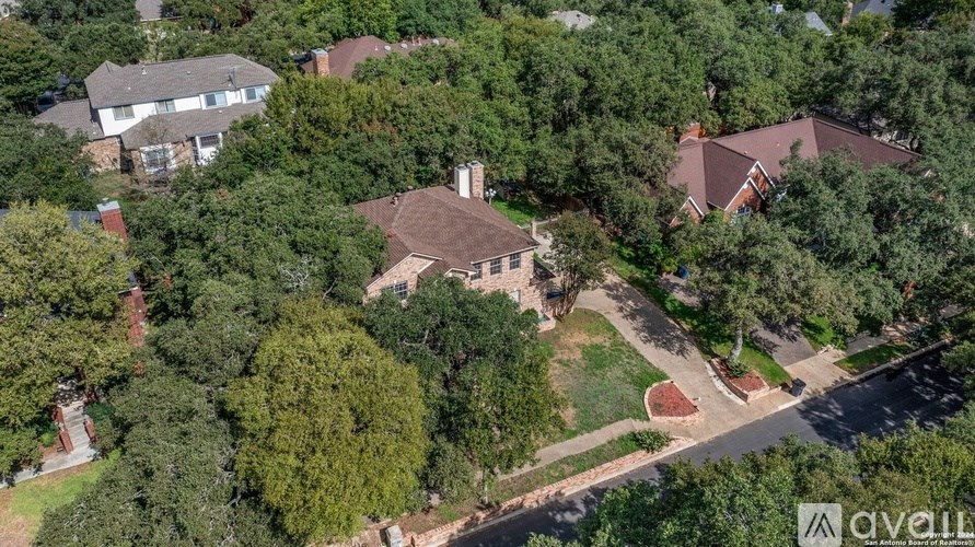 A bird's eye view of a house surrounded by trees.