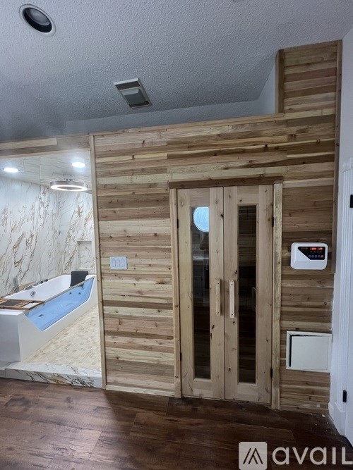 A room with wooden walls and a white door.