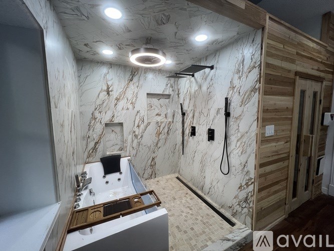 A bathroom with marble walls and a wooden vanity.