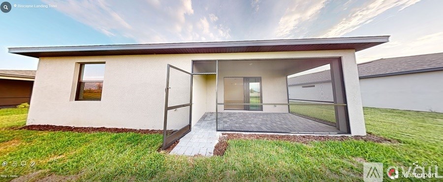 A modern house with a large glass door and a small porch.