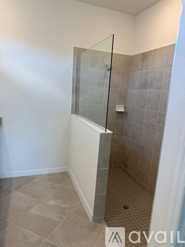 A tiled shower area with a glass door.