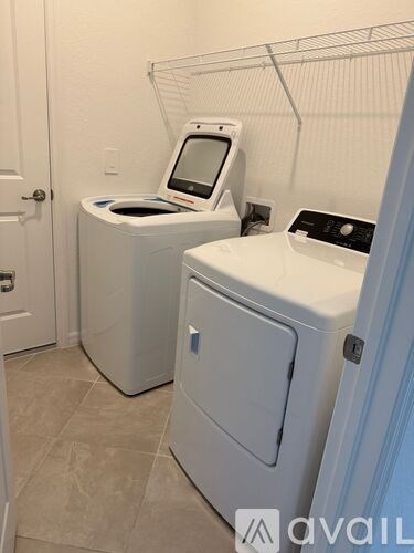 A white washing machine and dryer in a small laundry room.